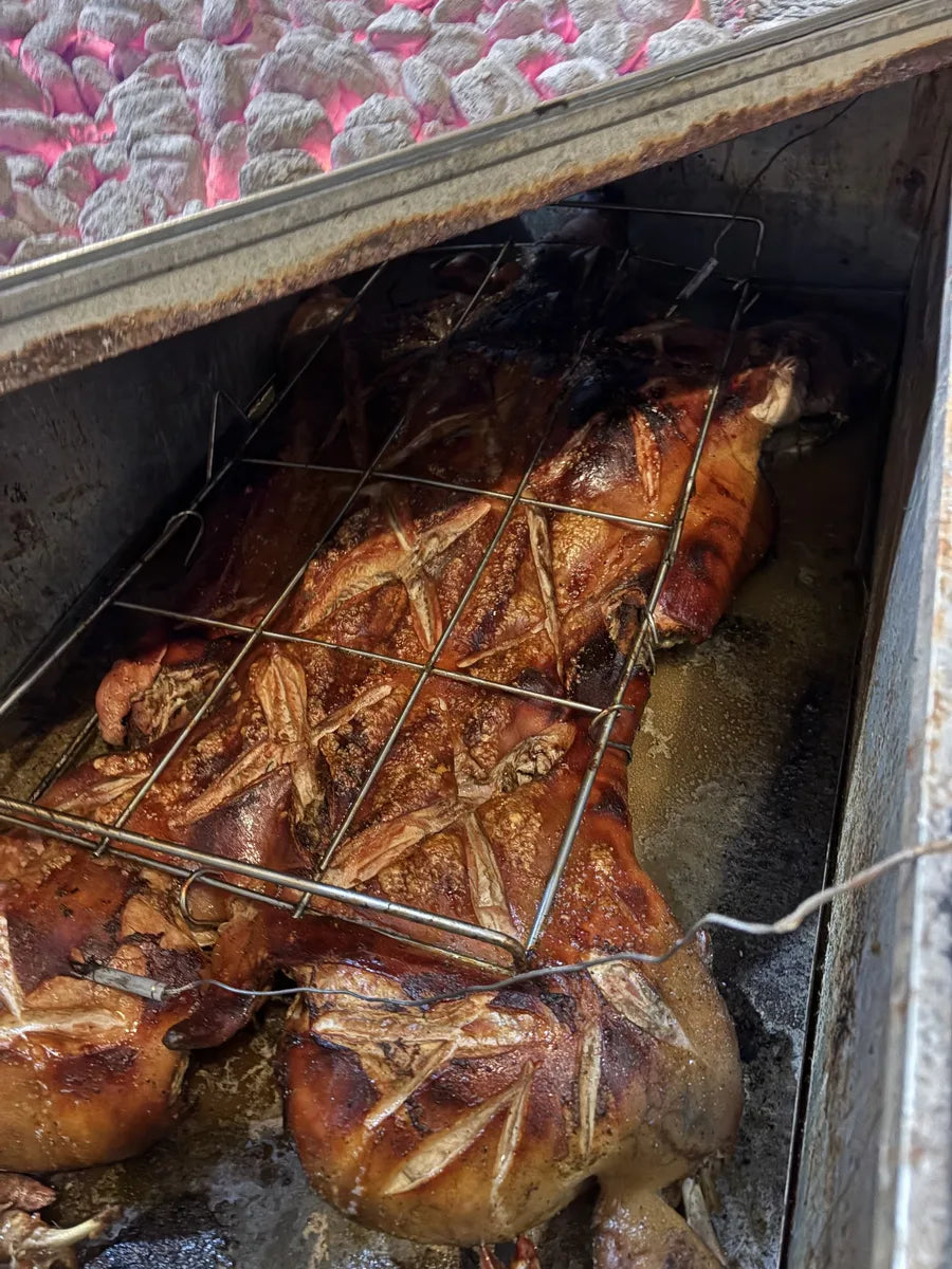 Lechon asado whole roast pork in a caja china with hot coals - traditional Cuban roast pork recipe by Barbaro Mojo